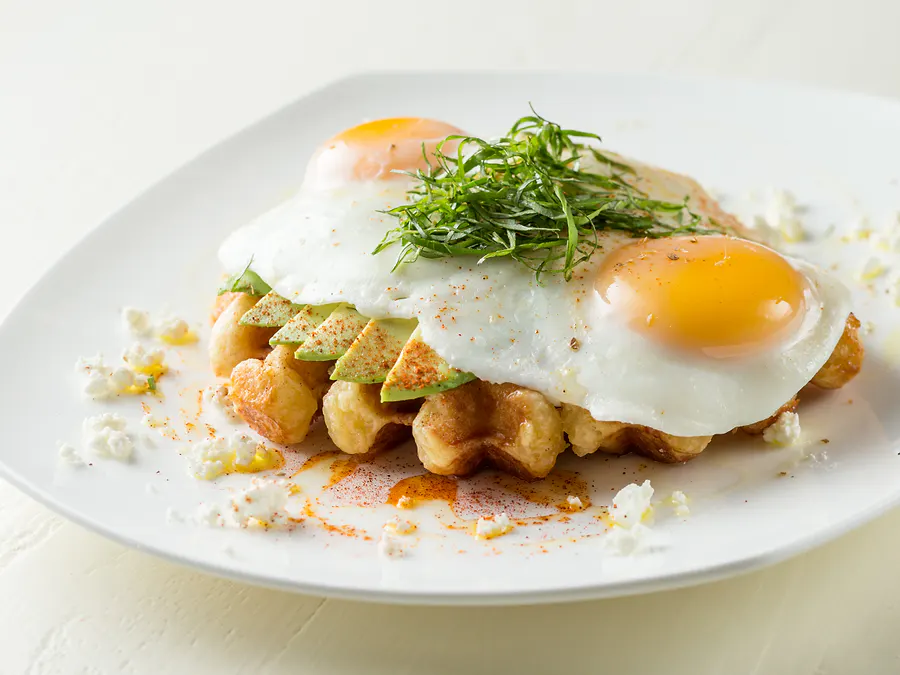 Goat In The Headlights — waffle with avocado, goat cheese and two sunny side up organic eggs